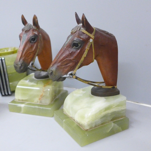 624 - A pair of cold painted bronze horses head bookends on an onyx plinth, an inkstand in the form of boo... 