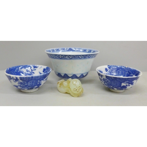 634 - Three blue and white bowls and a carved figure, largest bowl a/f