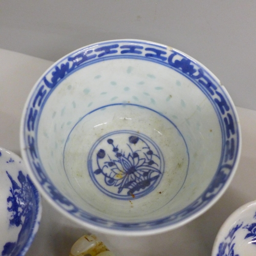 634 - Three blue and white bowls and a carved figure, largest bowl a/f