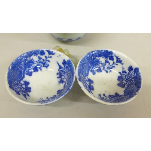 634 - Three blue and white bowls and a carved figure, largest bowl a/f