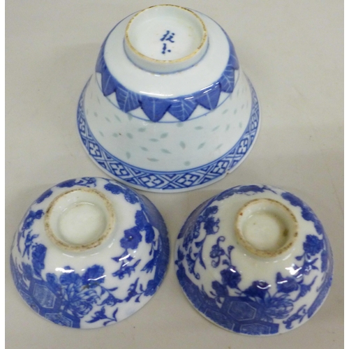 634 - Three blue and white bowls and a carved figure, largest bowl a/f