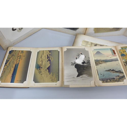 666 - Three albums of 112 early 20th century Japanese postcards and black and white photographs including ... 