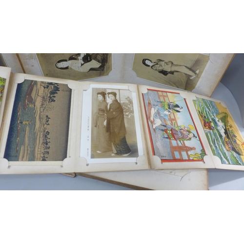 666 - Three albums of 112 early 20th century Japanese postcards and black and white photographs including ... 