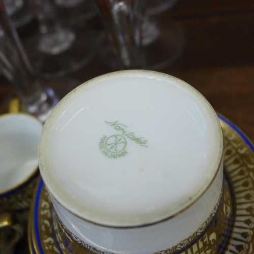 676 - A Noritake coffee set with blue and gilt decoration, six saucers, five coffee cans, a sugar bowl, mi... 