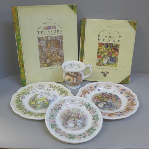 748 - Four Royal Doulton Brambly Hedge Season plates and one cup and two Brambly Hedge books