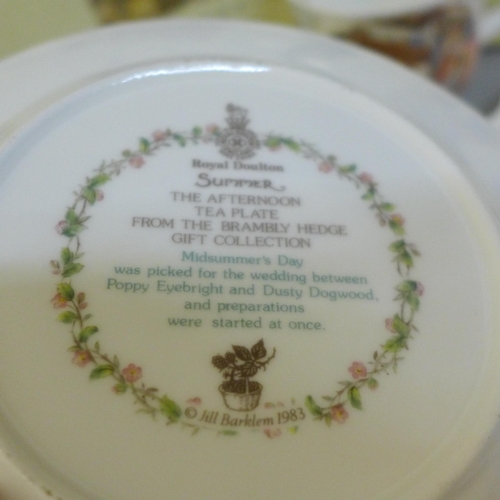 748 - Four Royal Doulton Brambly Hedge Season plates and one cup and two Brambly Hedge books