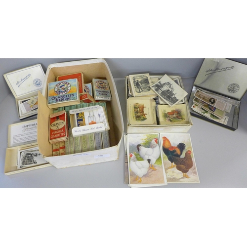 766 - A box of approximately thirty sets of cigarette cards in packets, Feathered World postcards, black a... 