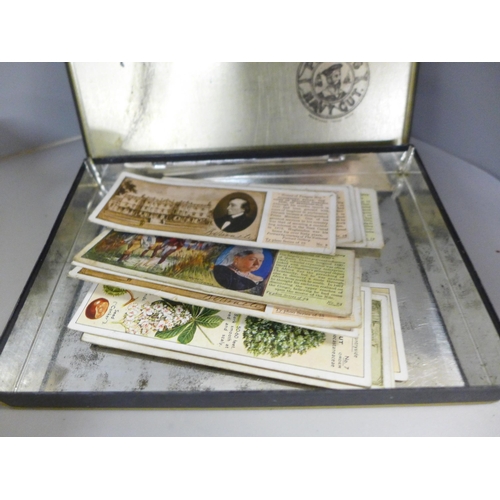 766 - A box of approximately thirty sets of cigarette cards in packets, Feathered World postcards, black a... 