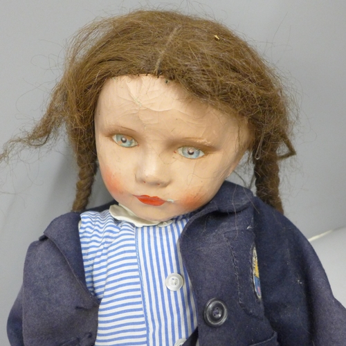 801 - A large 1940s composition doll in school uniform, cloth body, 60cm