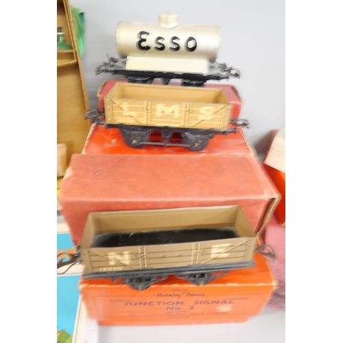 802 - A box of Hornby O gauge tinplate wagons, accessories, boxes and a 'Hornby Book of Trains' reprint of... 