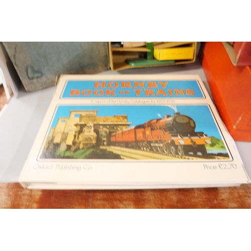 802 - A box of Hornby O gauge tinplate wagons, accessories, boxes and a 'Hornby Book of Trains' reprint of... 