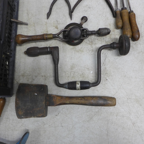 2022 - A large assortment of vintage tools including hand drills, mallets, a saw, brace drill, files, spiri... 