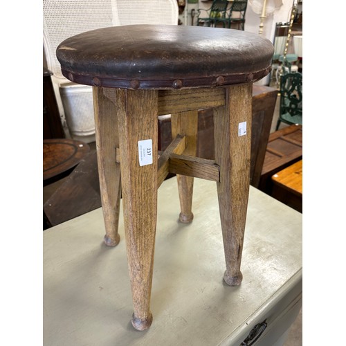 237 - An Arts & Crafts oak and leather topped stool