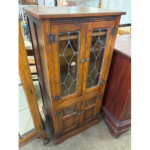 245 - An Old Charm carved oak four door stereo cabinet