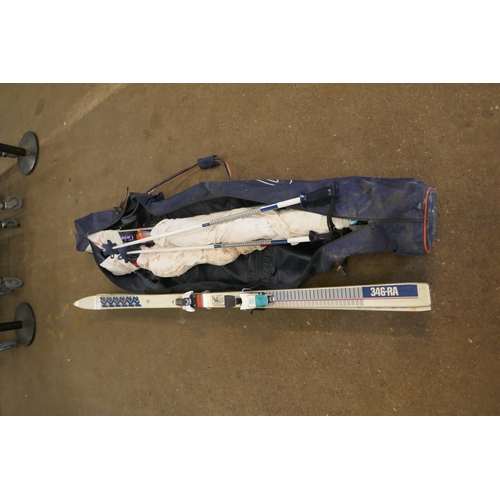 2176 - A quantity of skiing equipment including skis and poles with a carrying case