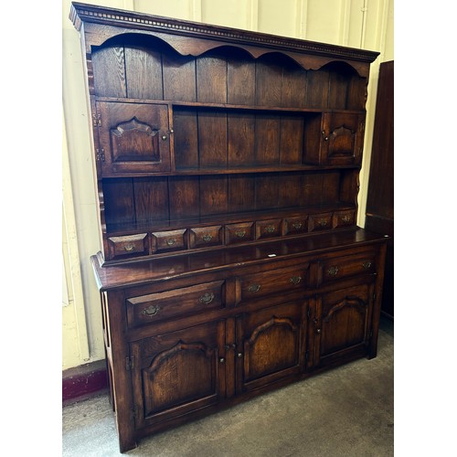 266 - A George III style carved oak dresser, manner of Titchmarsh & Goodwin