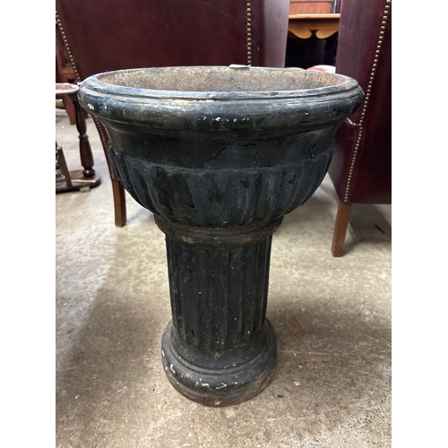 276 - A cast iron garden urn on stand