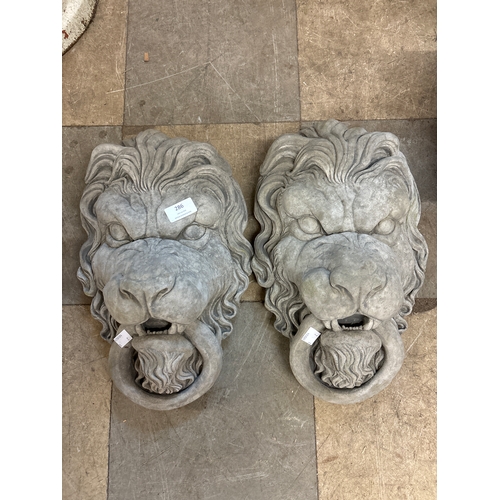 286 - A pair of lions heads garden ornaments