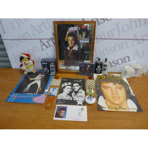 2299 - A crate of Elvis memorabilia including plates, mugs, posters, magazines, watches, wash set and two m... 