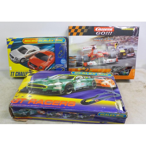 2417 - A selection of slot racing games including Micro Scalextric TT Challenge, Scalextric GT racers and a... 