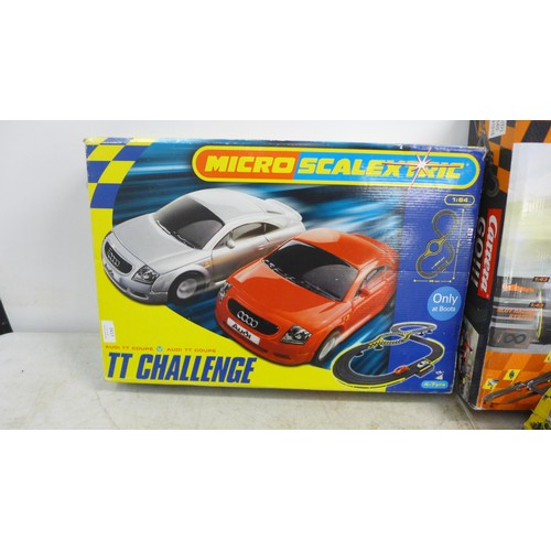 2417 - A selection of slot racing games including Micro Scalextric TT Challenge, Scalextric GT racers and a... 