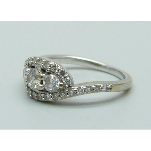 1010 - A white metal diamond set cluster ring, L, 3.9g