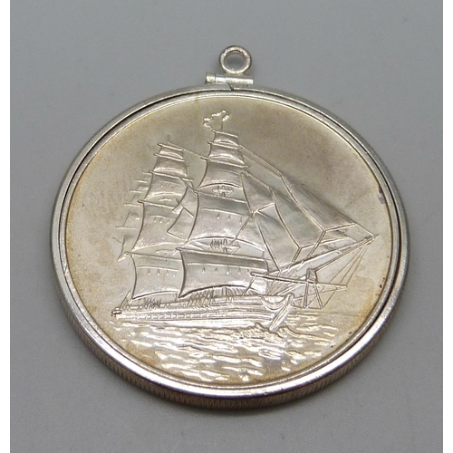 1021 - One ounce .999 silver Trade Unit with mounting in a silver bezel, 33g