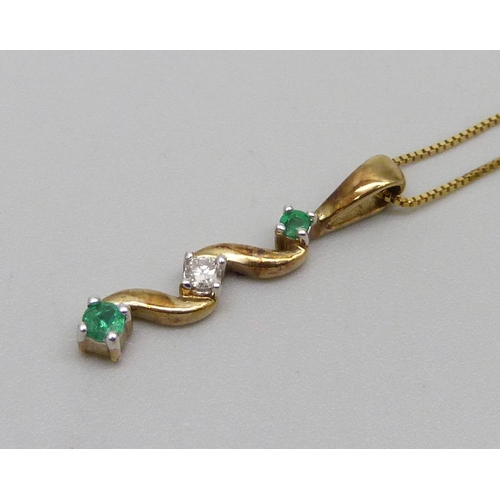 1029 - A 9ct gold pendant on chain, set with emeralds and a diamond, 1.8g