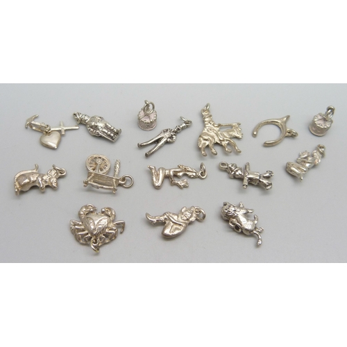 1053 - Fifteen silver and white metal charms, 31g