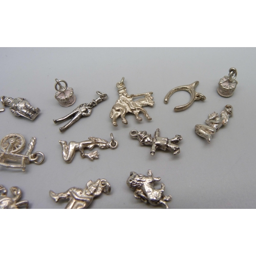 1053 - Fifteen silver and white metal charms, 31g