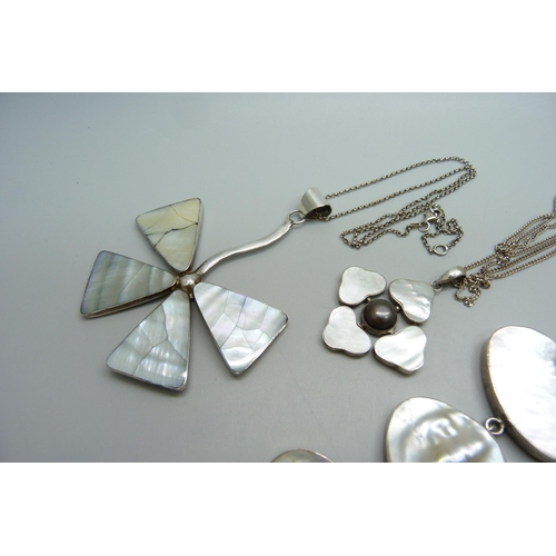 1066 - Two silver and mother of pearl pendants and chains and a silver mother of pearl bracelet