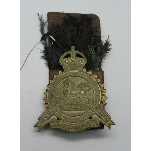 1087 - A South African Constabulary Edwardian Slouch Hat Badge depicting a lion standing on a snake