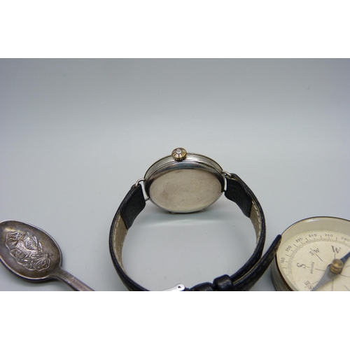 1124 - A silver trench watch, one other lady's silver wristwatch, a Helios wristwatch, Rolex spoon and comp... 