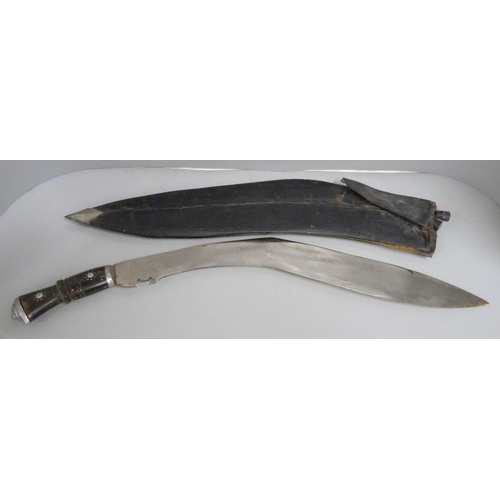 832 - A large Kukri with two smaller examples, with scabbard, a/f