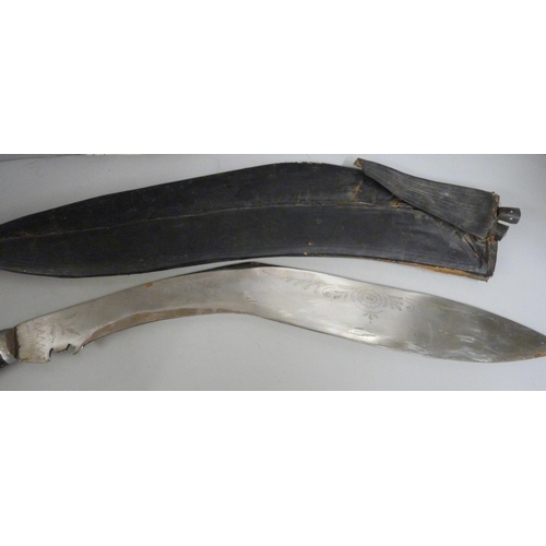 832 - A large Kukri with two smaller examples, with scabbard, a/f