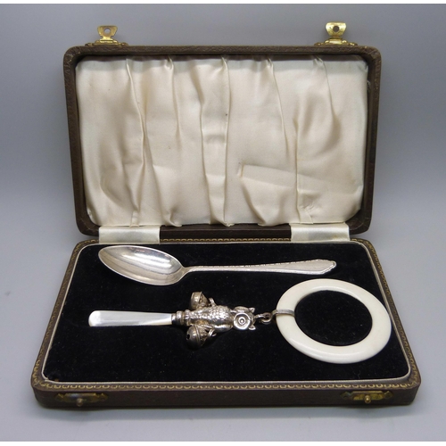 869 - A hallmarked silver Christening set, owl rattle and spoon, spoon 24g and 137mm