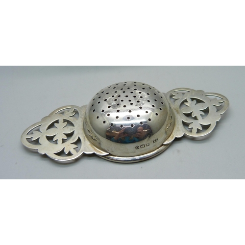 880 - A silver strainer and two silver topped peppers/condiments, silver 46g