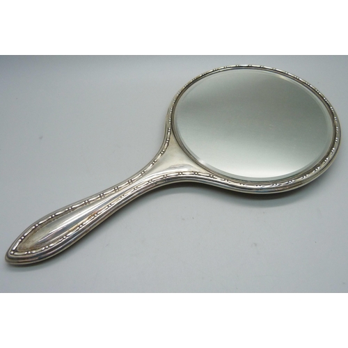 883 - A silver backed hand mirror