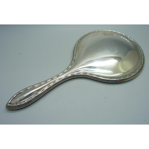 883 - A silver backed hand mirror