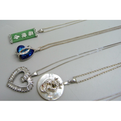 909 - Seven silver pendants and chains