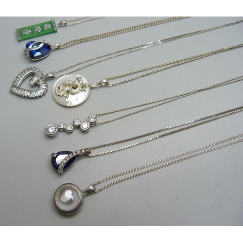 909 - Seven silver pendants and chains