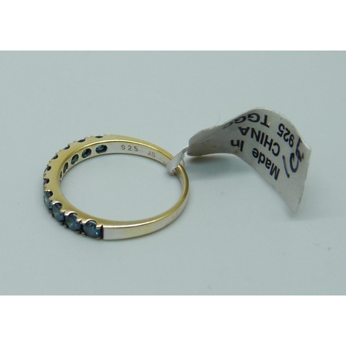 955 - A silver gilt and blue stone half eternity ring, S