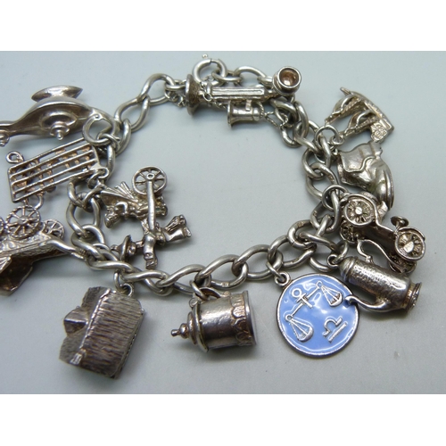 968 - A silver charm bracelet, 48.9g