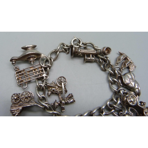 968 - A silver charm bracelet, 48.9g