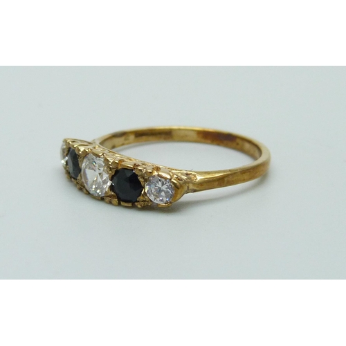 991 - A 9ct yellow gold sapphire and clear stone ring, O, 2.5g