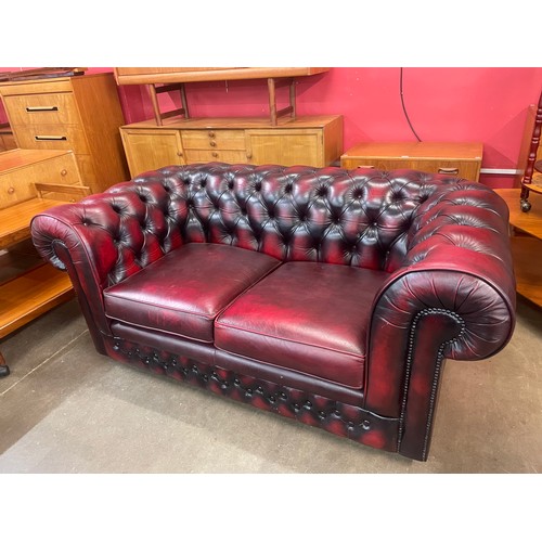 121 - A Thomas Lloyd oxblood red leather Chesterfield settee