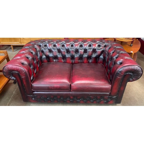 121 - A Thomas Lloyd oxblood red leather Chesterfield settee