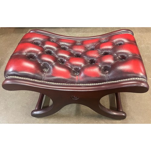 121A - An mahogany and oxblood red leather Chesterfield footstool
