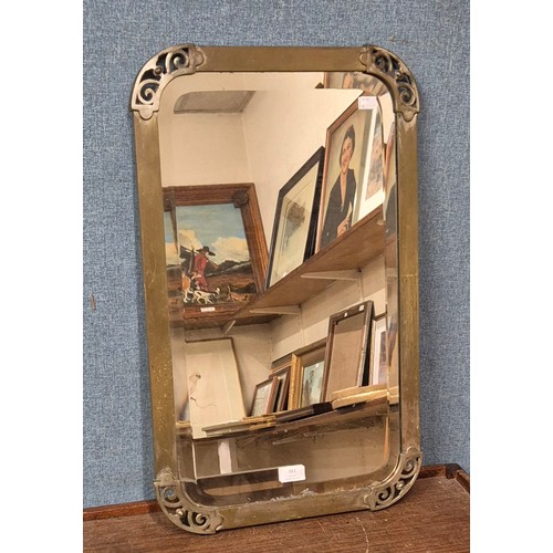 351 - An Art Deco brass framed mirror