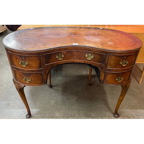 132 - A Queen Anne style walnut kidney shaped desk